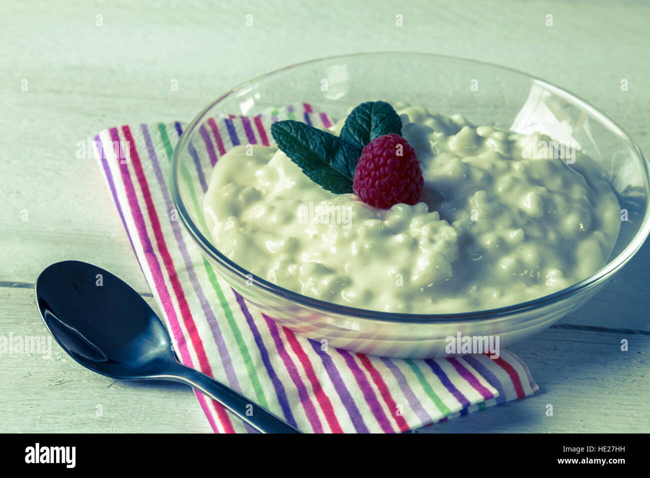 Rice pudding with mint and raspberry Stock Photo - Alamy