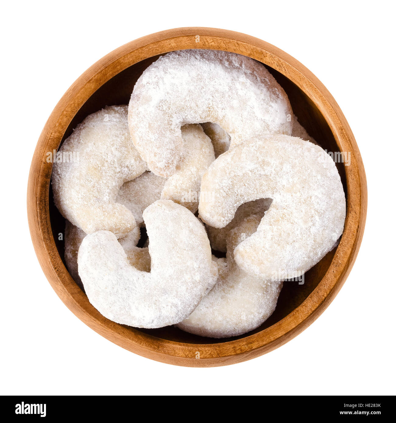 Crescent-shaped vanilla biscuits in wooden bowl. Vanilla almond half moons, Vanillekipferl. Austrian christmas cookie scecialty. Stock Photo