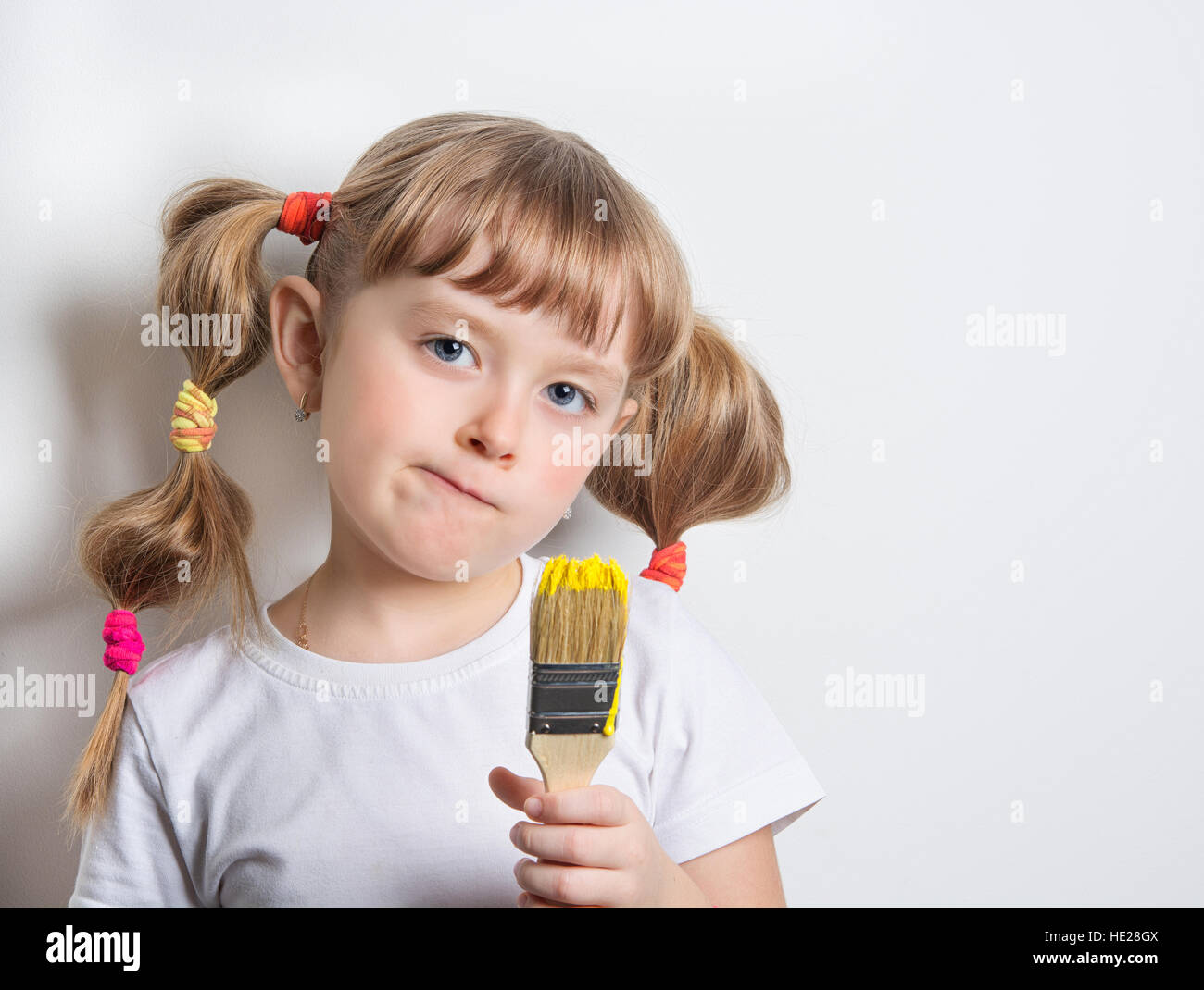 child with a brush paints Stock Photo Alamy