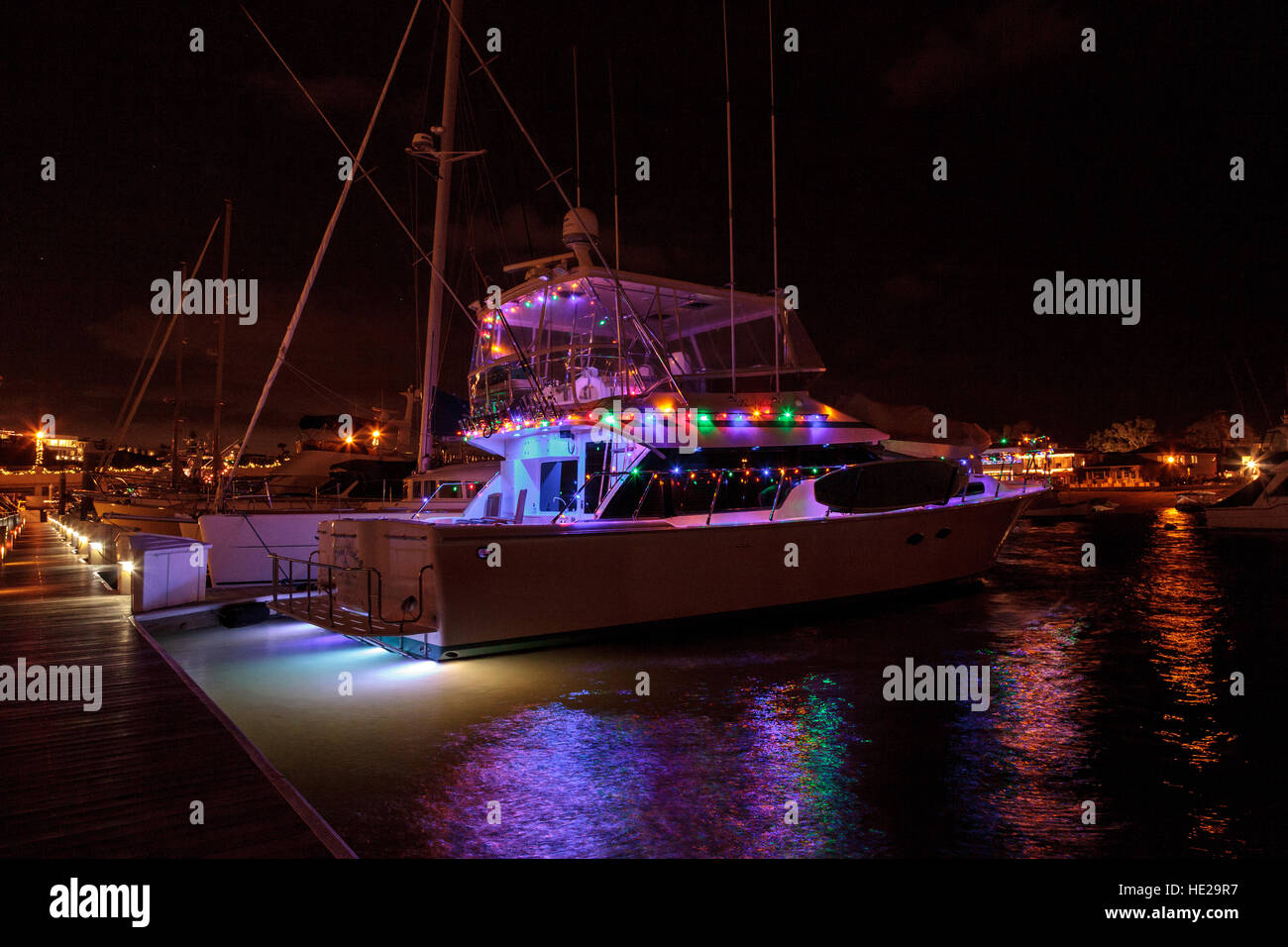 Colorful holiday lights on sailboats and ships in the Balboa Harbor for