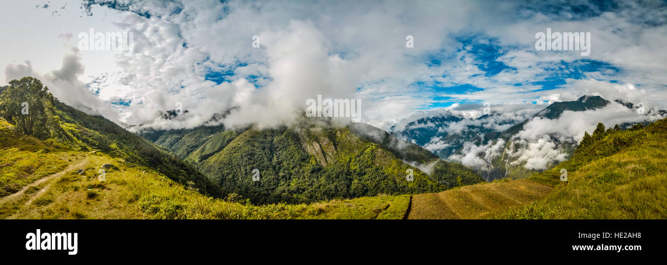 Panoramic view of mountains in morning fog in Dani circuit near Wamena, Papua, Indonesia. In this region, one can only meet people from isolated local Stock Photo