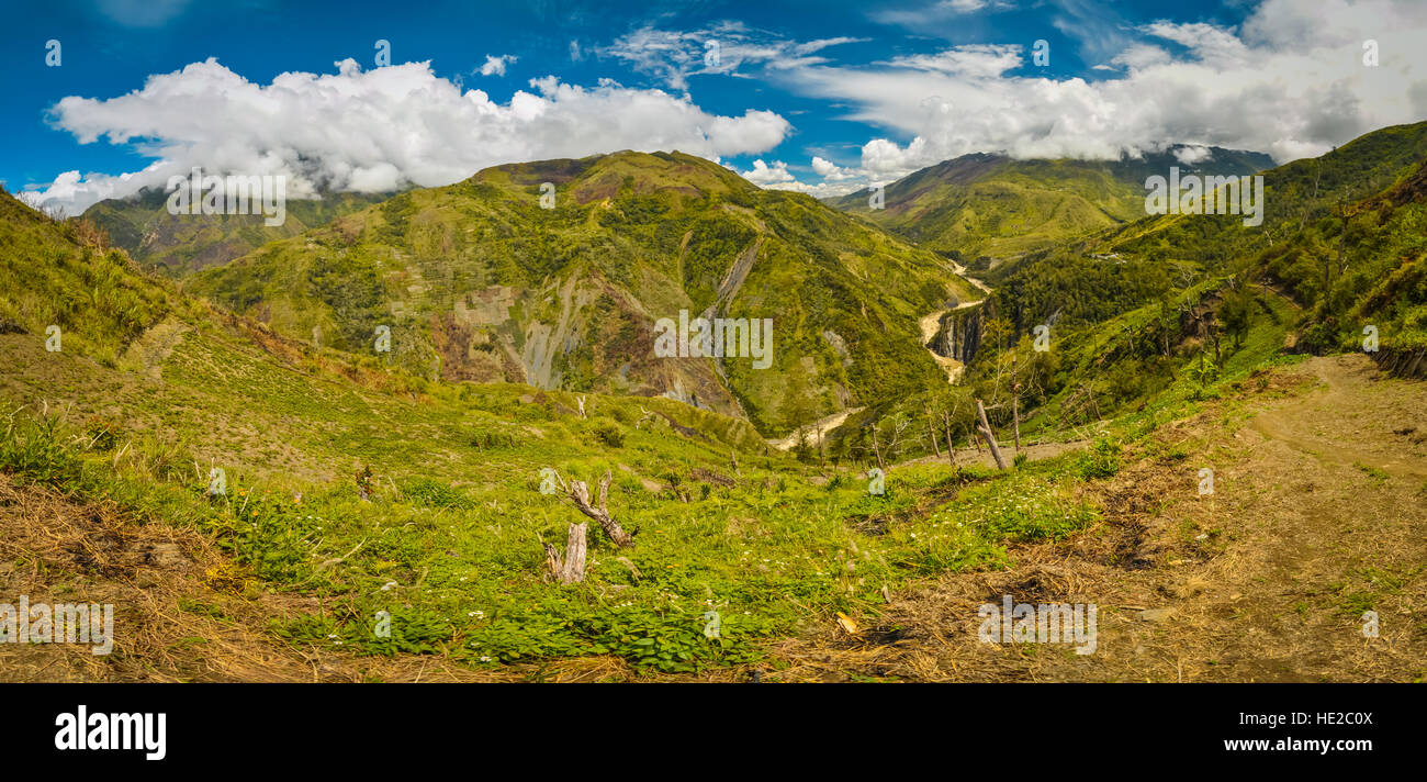 Panoramic view of mountains and rich greenery in mountainous region of Dani circuit near Wamena, Papua, Indonesia. Stock Photo