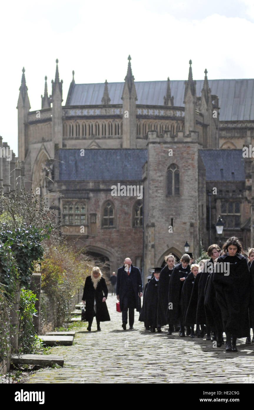 Choristers from Wells Cathedral Choir walking along Vicars Close with Wells Cathedral in the background, on Easter Sunday. Stock Photo