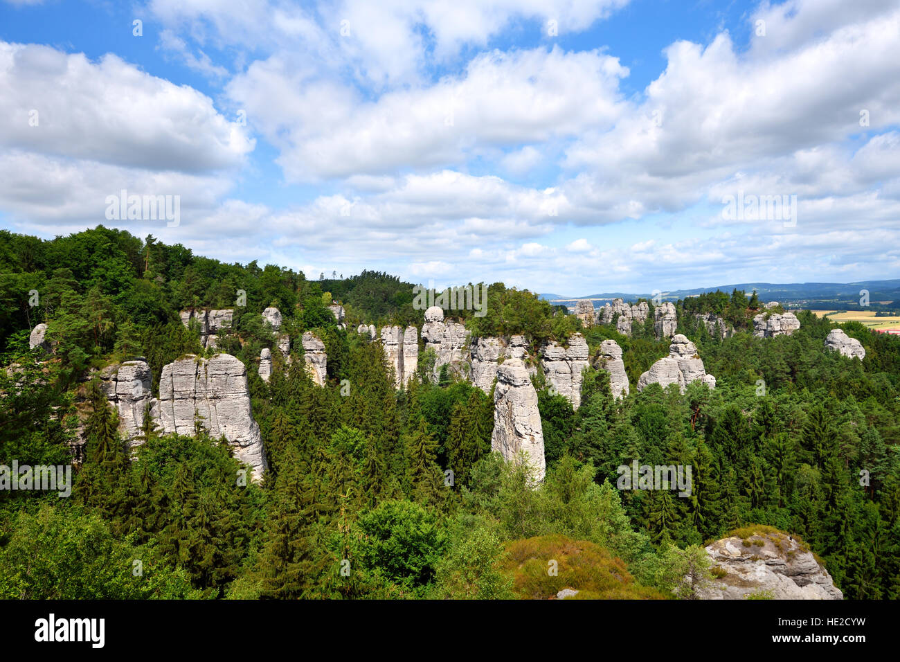 Sandstone rock towers in green forest area Stock Photo