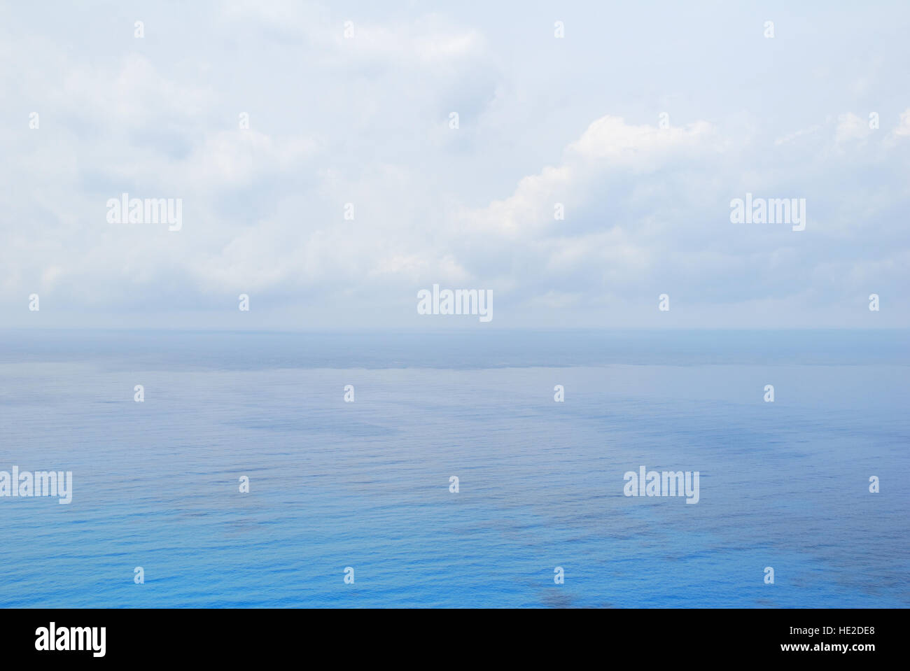 Blue open sea water under cloudy sky Stock Photo - Alamy