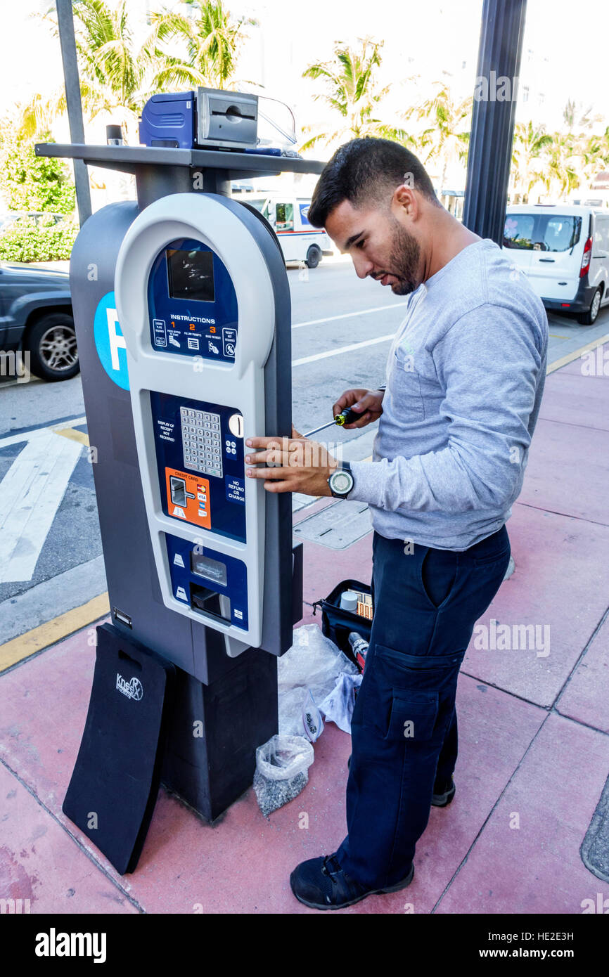 Miami Beach Florida,Hispanic adult,adults,man men male,parking meter,technician,repairman,working,fixing,repairing,FL161125034 Stock Photo