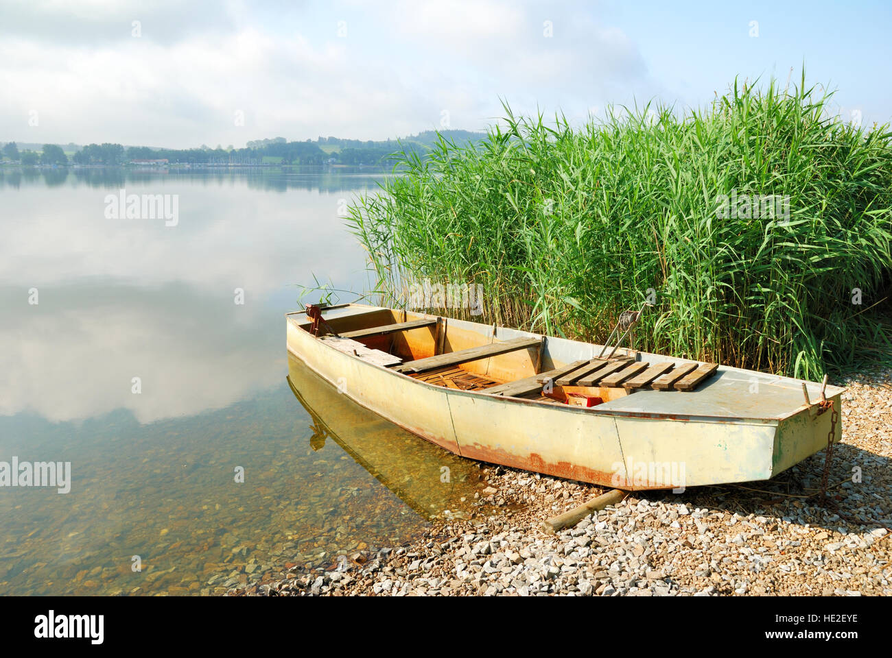Old fishing boat on a lake shore Stock Photo - Alamy