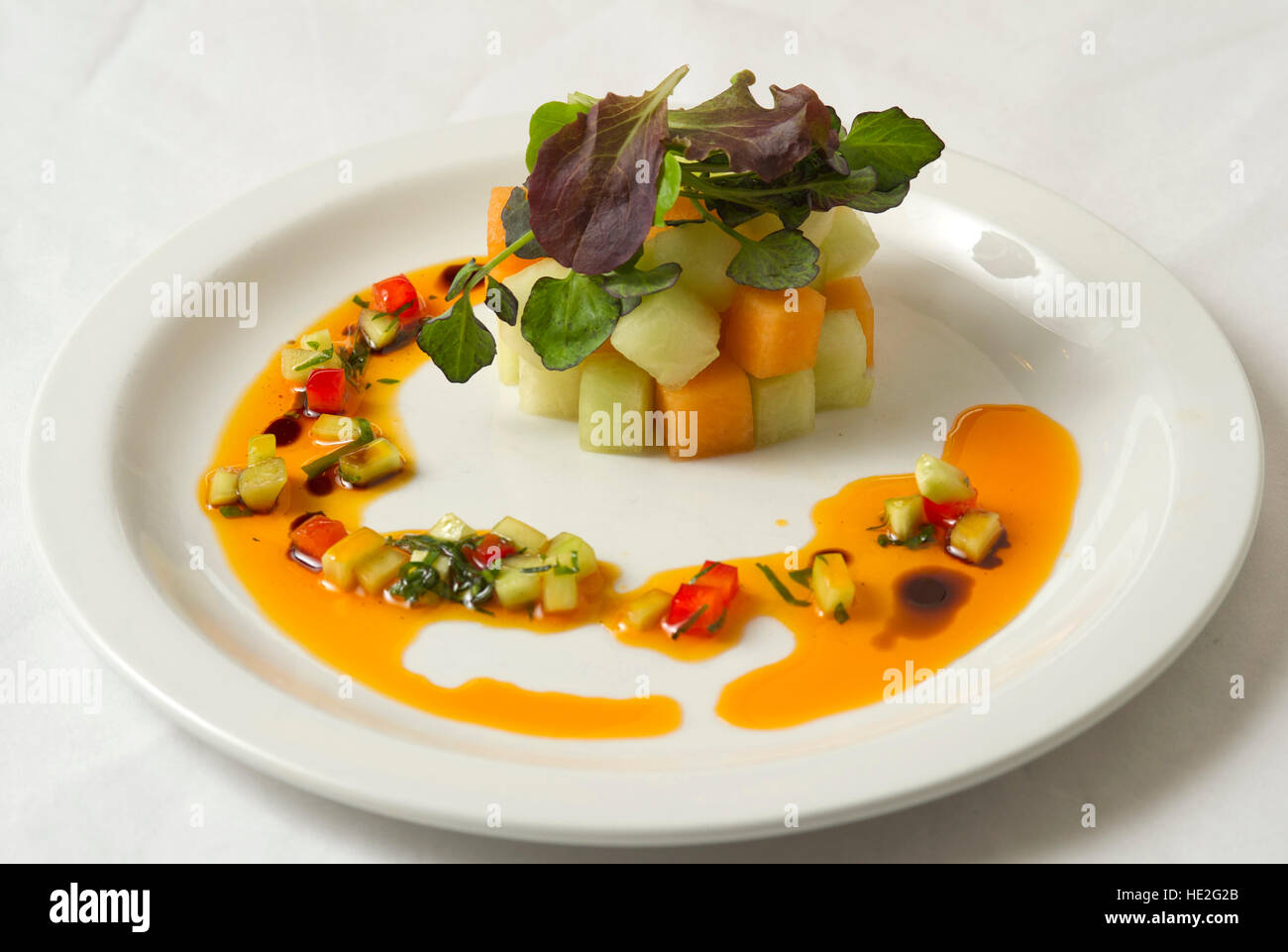 A fruit salad with water melon and mango with green leaves Stock Photo
