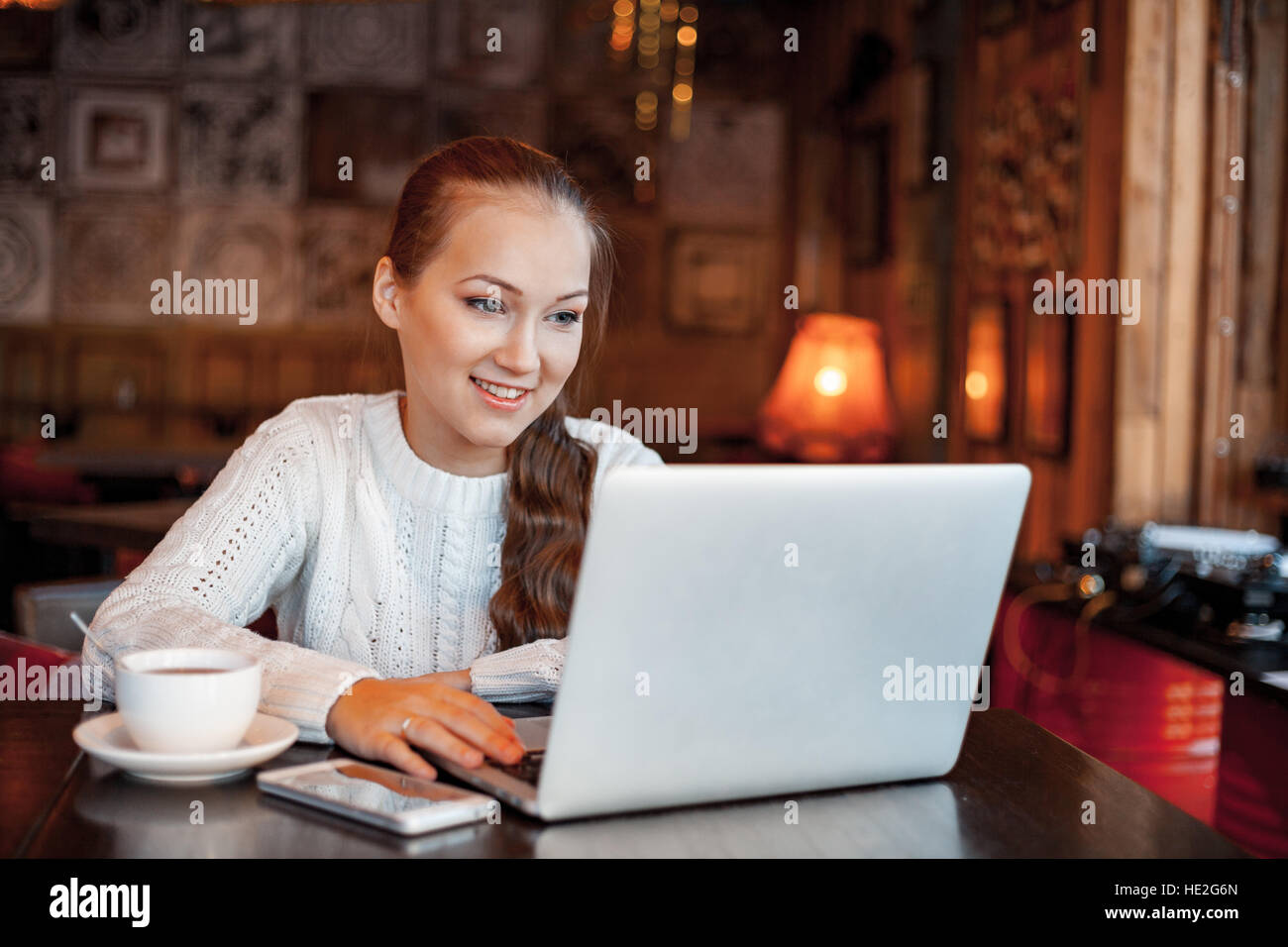 Yong woman a work at laptop in cafe Stock Photo