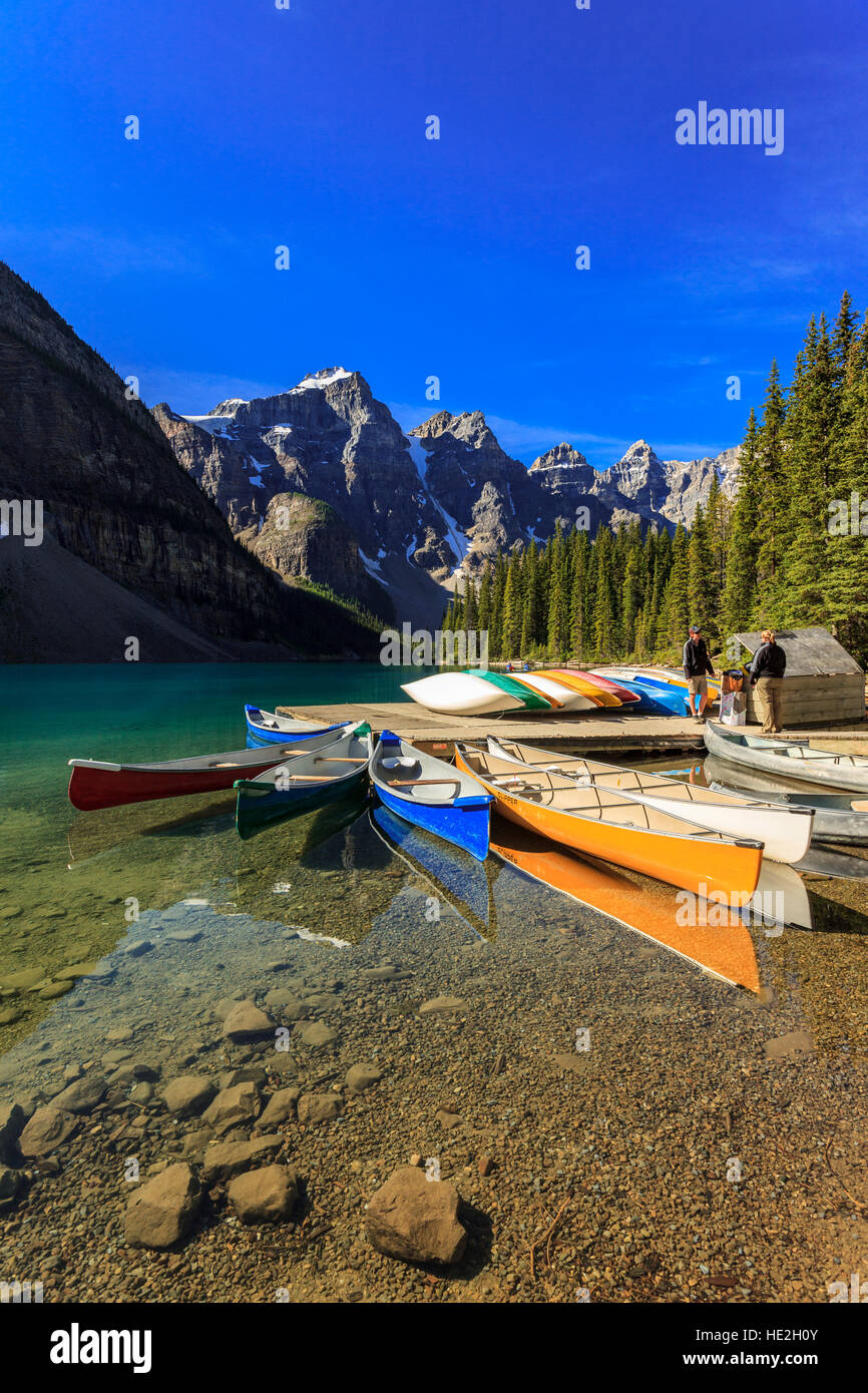 Rental canoes moored at the dock at Moraine Lake in Banff National Park Alberta Canada Stock Photo