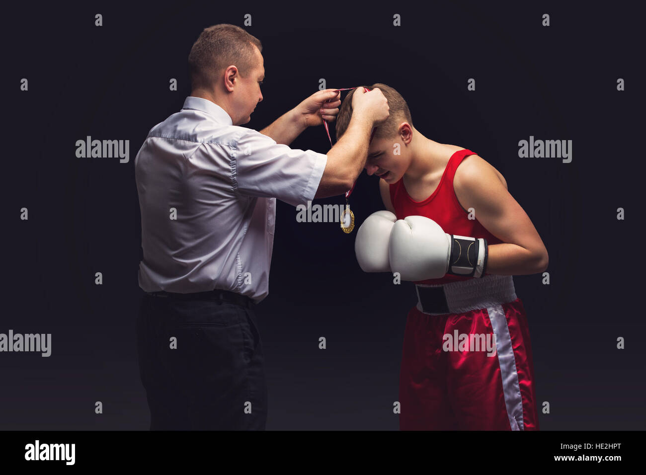 Boxing referee gives medal to young boxer Stock Photo Alamy