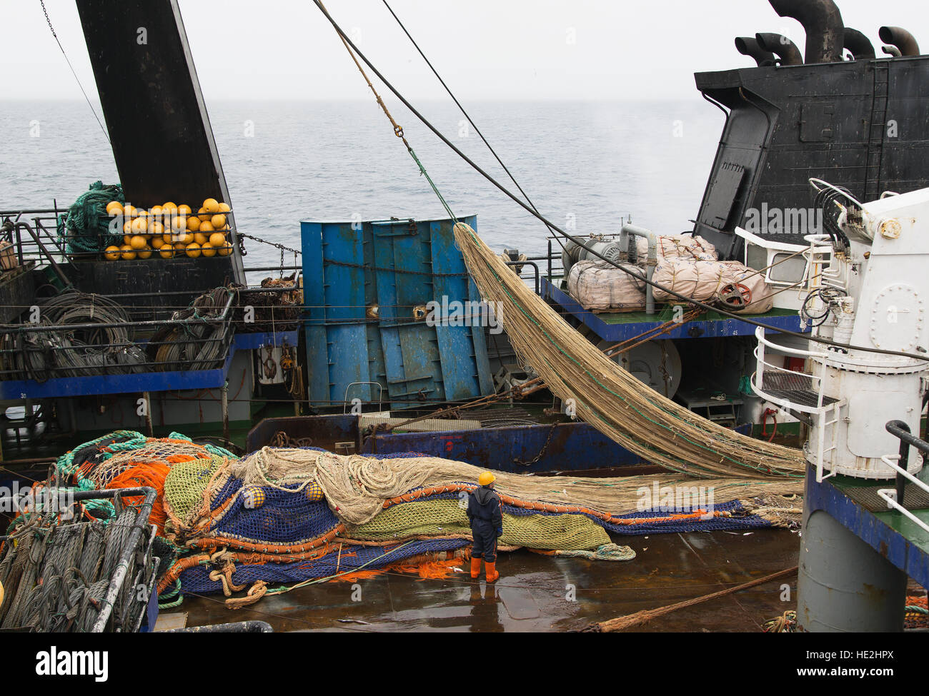 The Bering Sea, Russia - Jun 18th, 2016: The Bering Sea, seiner V. STARZHINSKY, the seaman to place a fishing net on a deck. Stock Photo