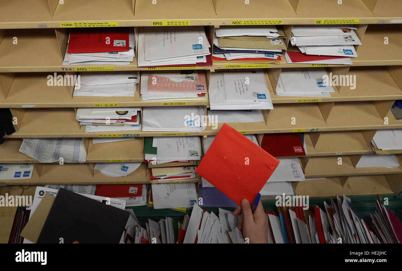A Royal Mail worker sorts mail at the Royal Mail's Sorting Office in