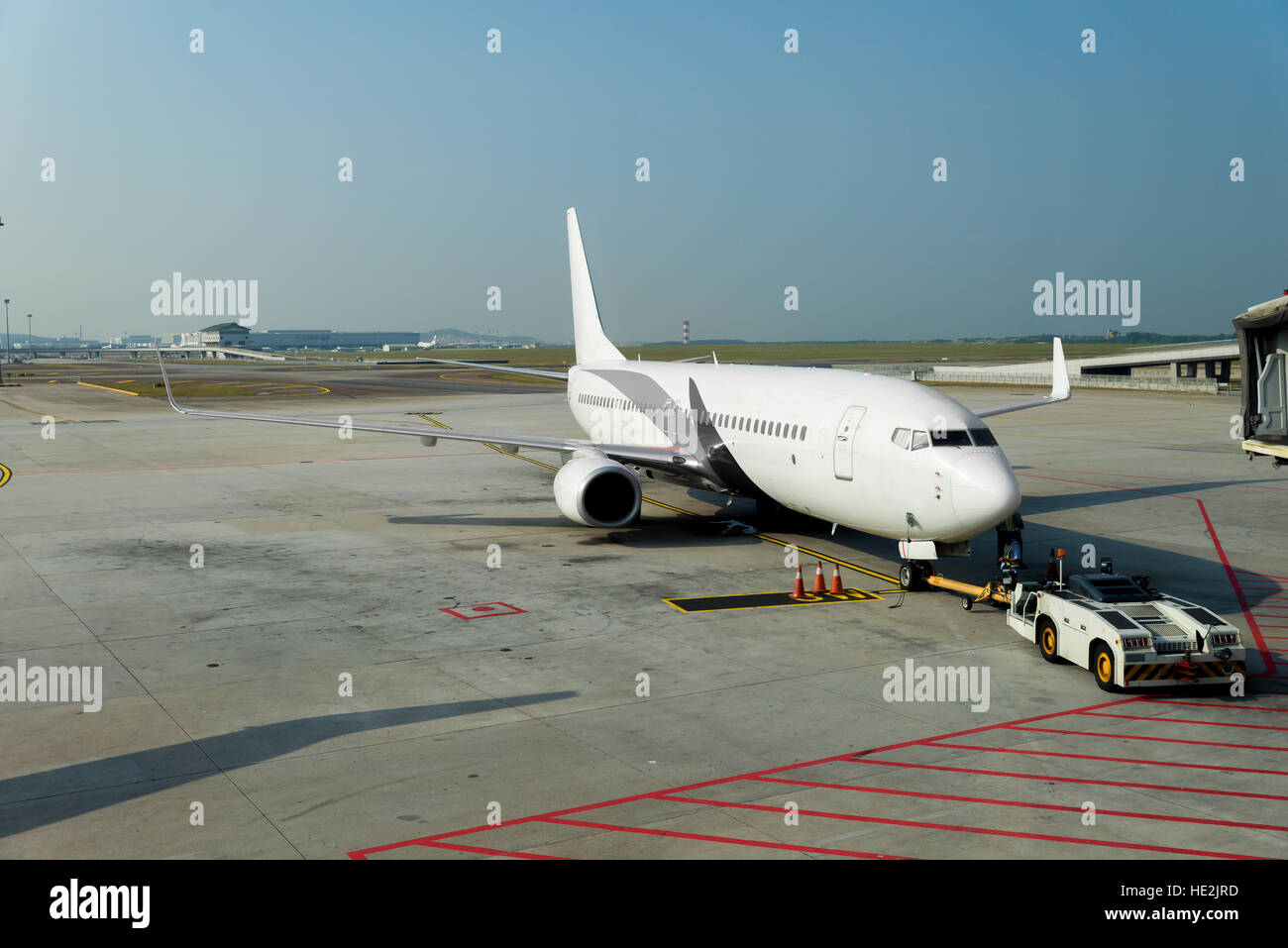 Airplane at the terminal gate ready for takeoff in modern international airport. Stock Photo