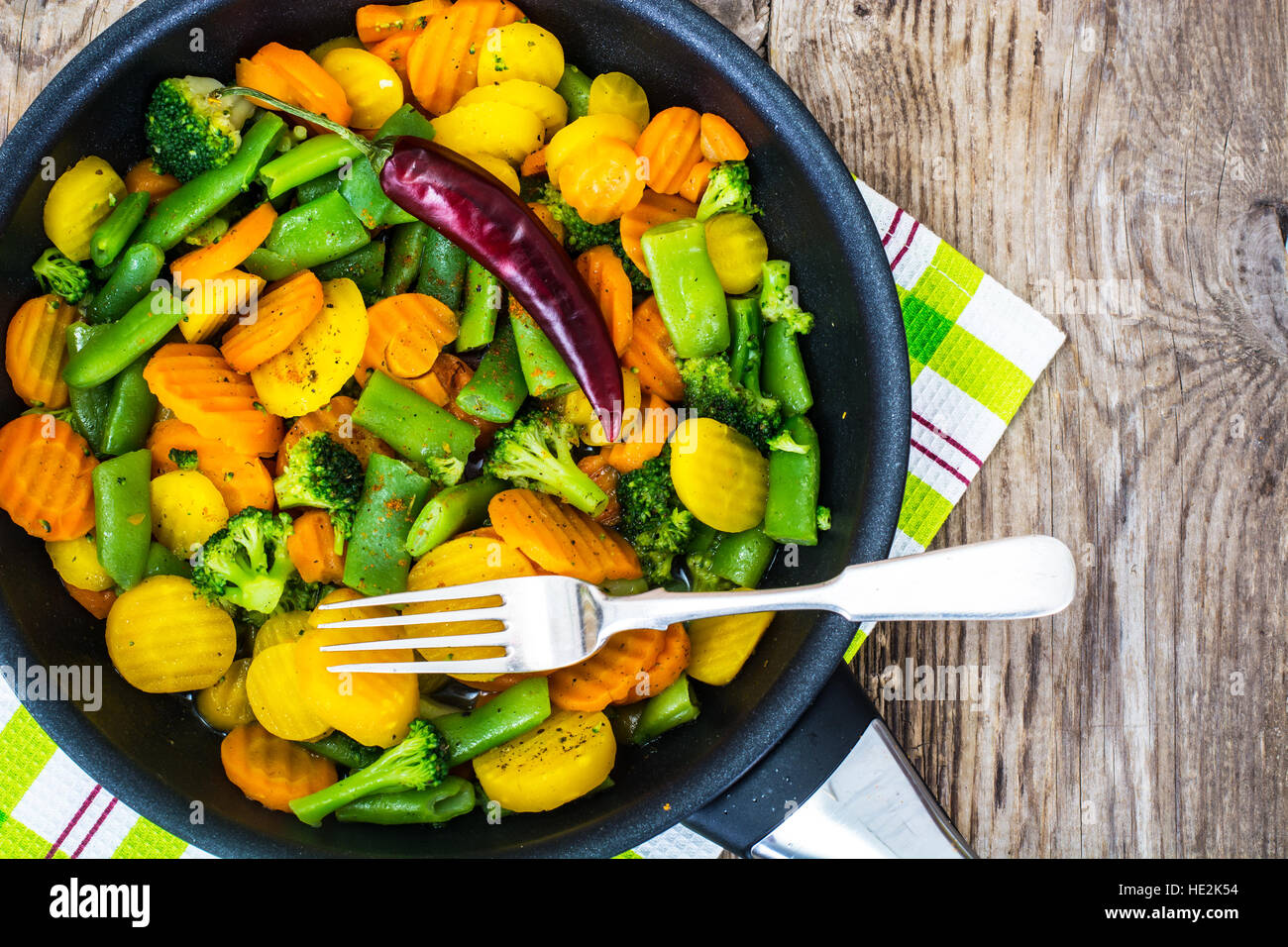 Stewed vegetables carrots, green beans and broccoli in a frying Stock