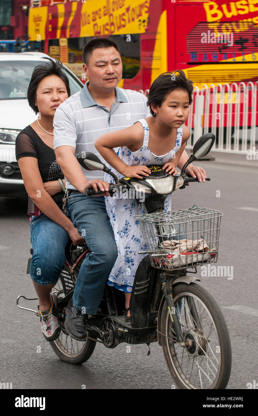 A family riding motorcycle bike cycle in street scene, XIan, China. Stock Photo