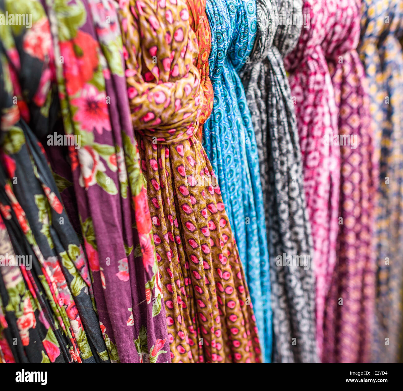 Hanging scarfs for sale in a shop. Stock Photo