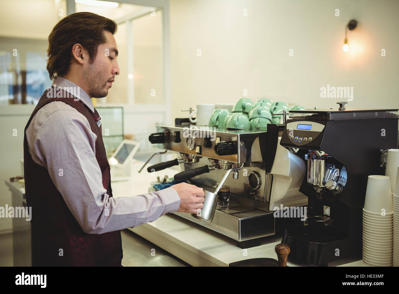 Man preparing coffee in coffee machine at coffee shop Stock Photo Alamy