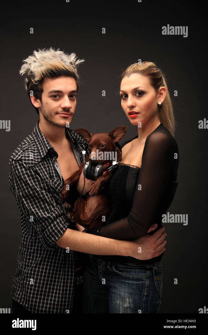 portrait of a young stylish couple with a dog Stock Photo - Alamy