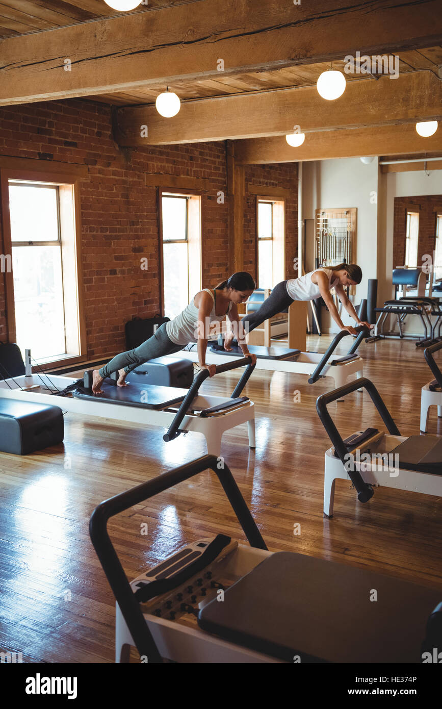Women practicing pilates on reformer in fitness studio Stock Photo Alamy
