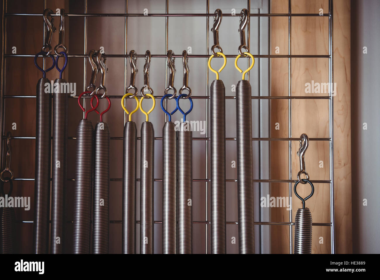 Various exercise equipment hanging on frame in fitness studio Stock Photo