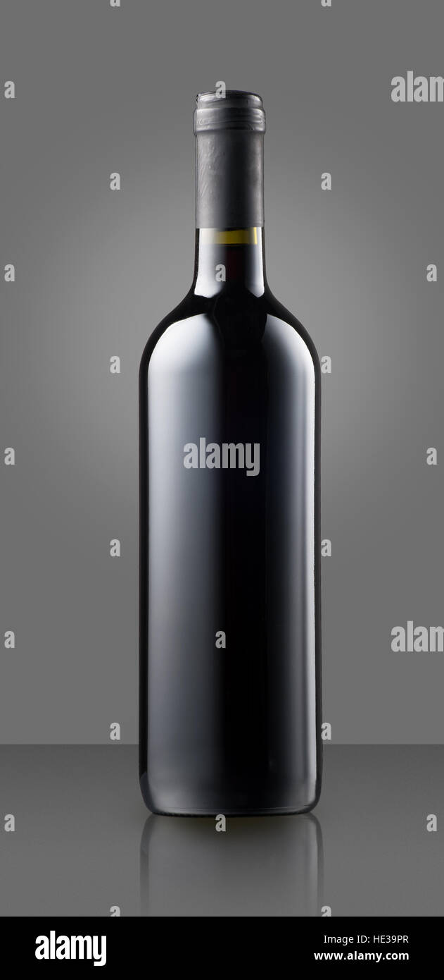 Blank full capped red wine bottle on gray with copy space for a label or branding for a winery Stock Photo