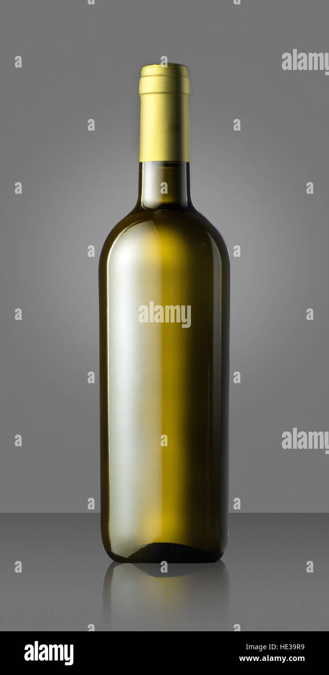 Single unlabeled full corked green white wine bottle on gray in a concept of viticulture Stock Photo