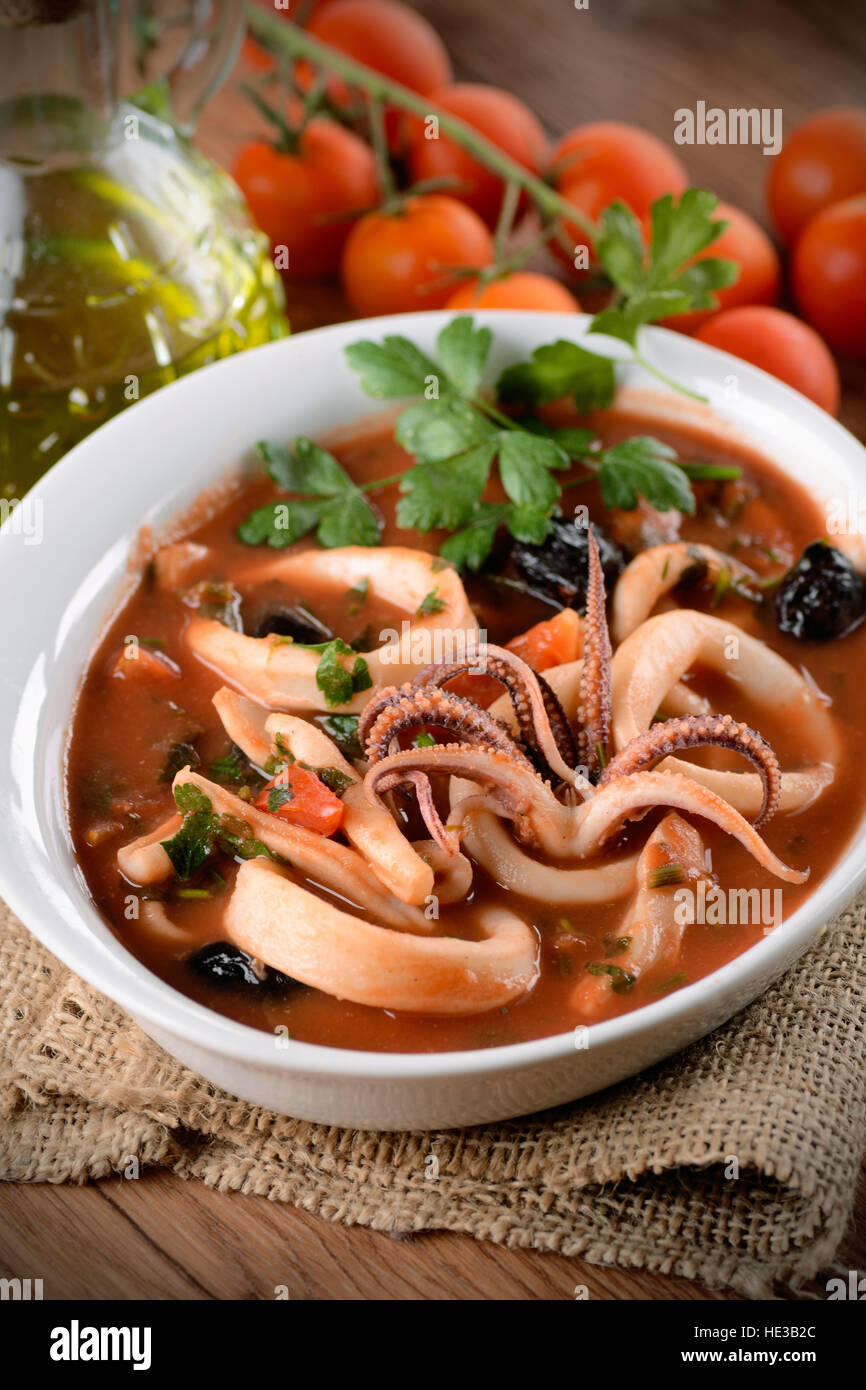squid soup with tomato and black olives in the bowl Stock Photo Alamy