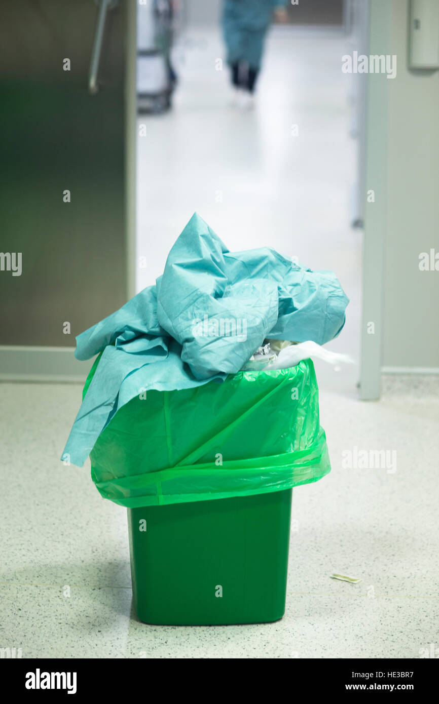 Operating theater surgery trash bin with green plastic bag used to dispose of disposable rubbish after surgical procedure. Stock Photo