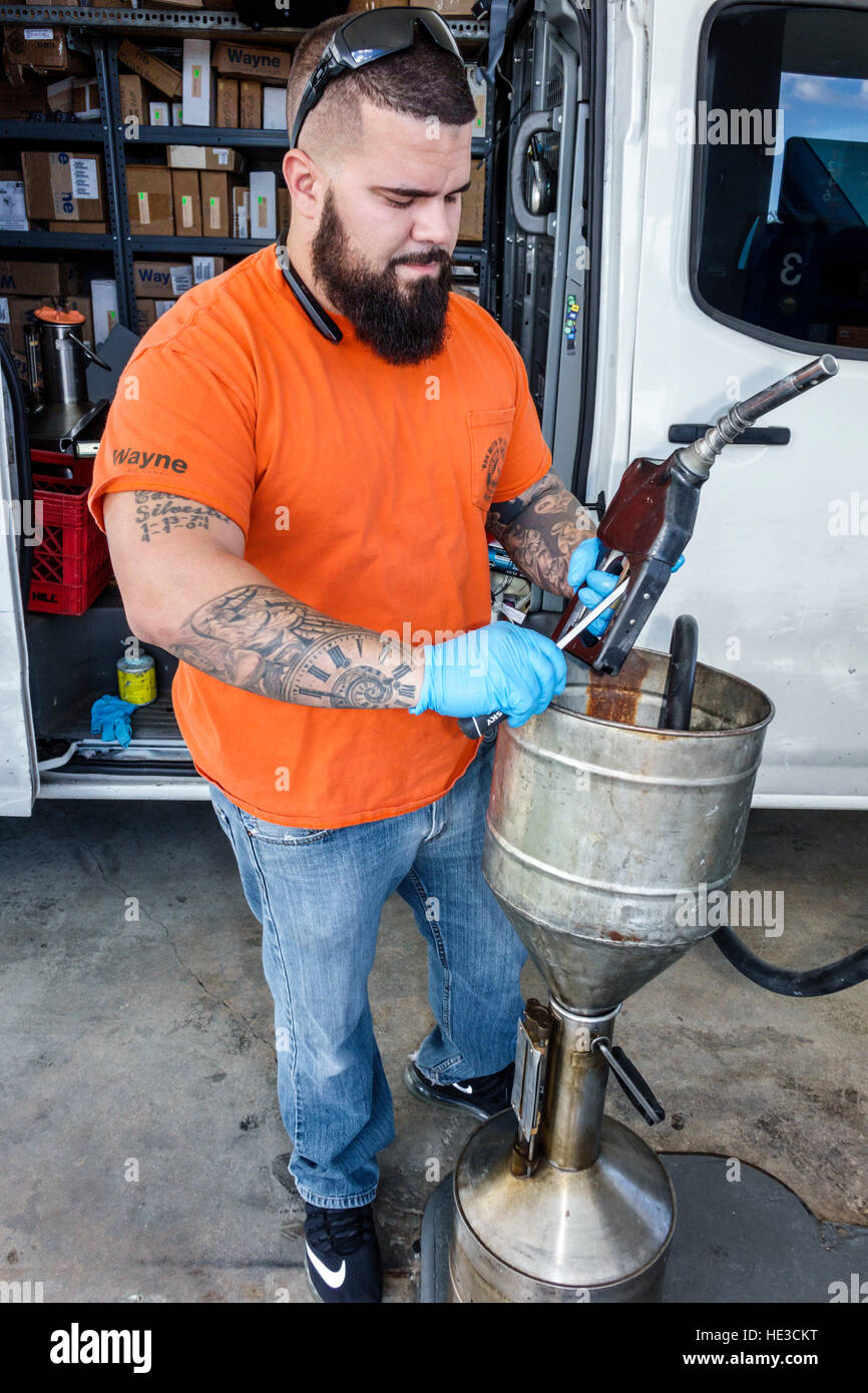 Miami Florida,Hialeah,gas station,petrol,Hispanic adult,adults,man men male,repairing pump handle,FL161125052 Stock Photo