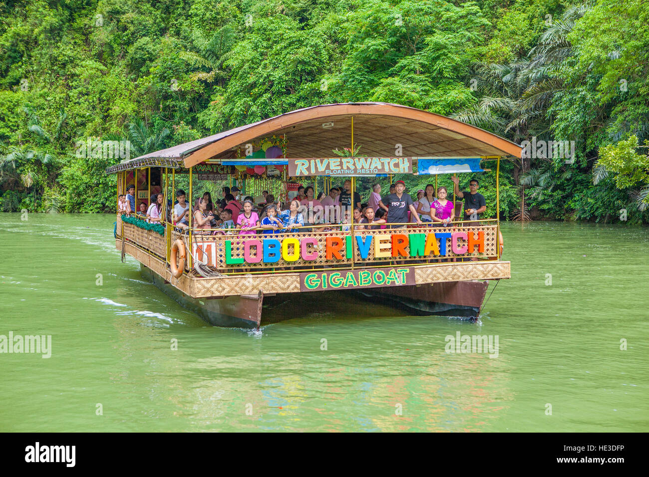 Vacationers enjoy a dinner and cruise on the Loboc River with Riverwatch Gigaboat tours on Bohol Island, Philippines. Stock Photo