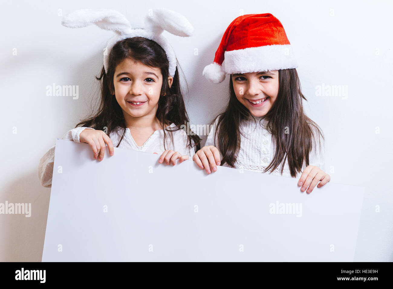Two girls posing for Christmas and New Year holidays Stock Photo - Alamy