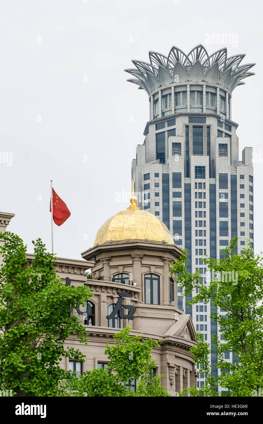 The Chinese national flag and Bund Center building , Shanghai, China. Stock Photo