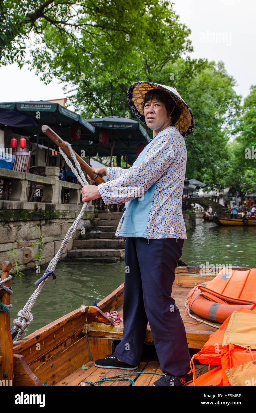 chinese gondola canal boat driver the water village of Tongli, China