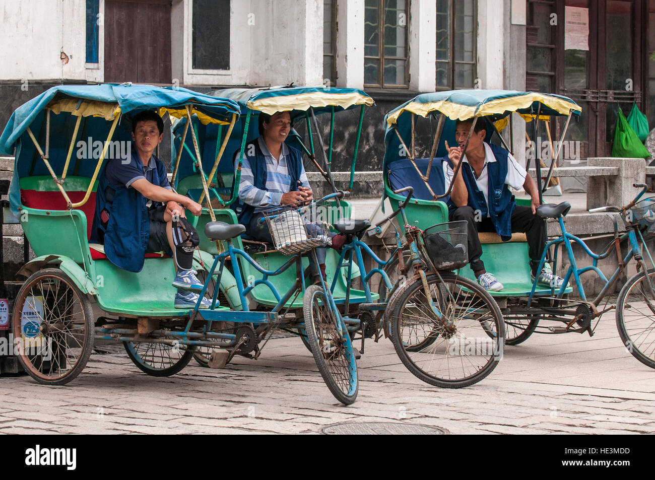 Cycle rickshaws trishaws taxis drivers in the water village of Tongli, China. Stock Photo