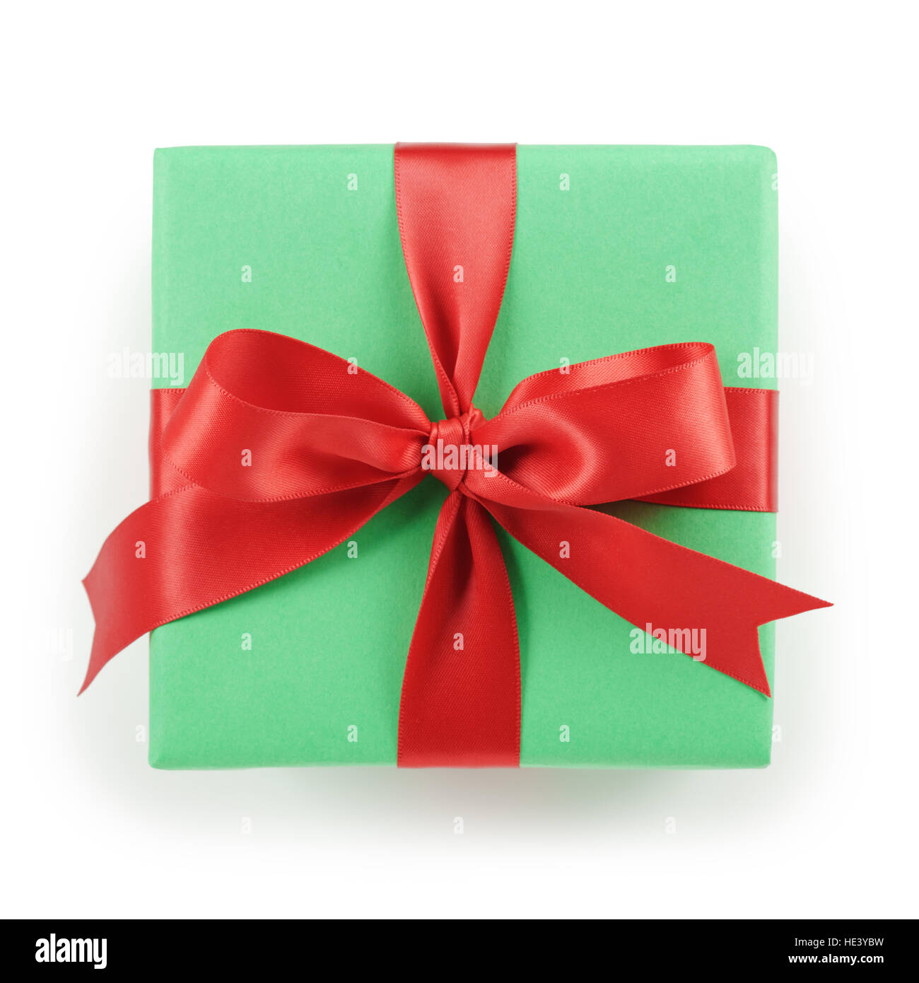 green paper gift box with red ribbon bow top view on white background Stock Photo