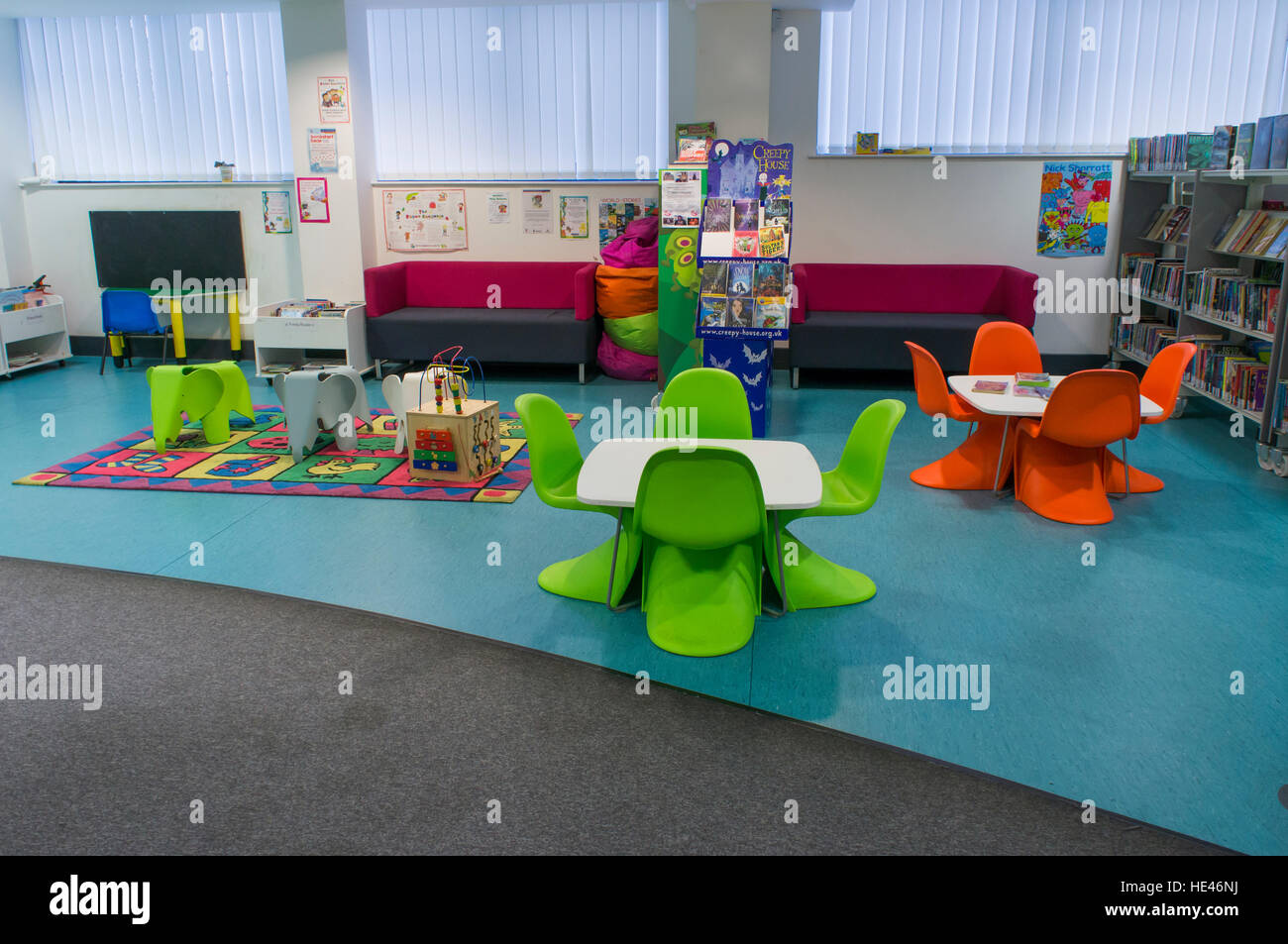Library interior, West Yorkshire, England bookshelves with rows of books, tables and chairs in
