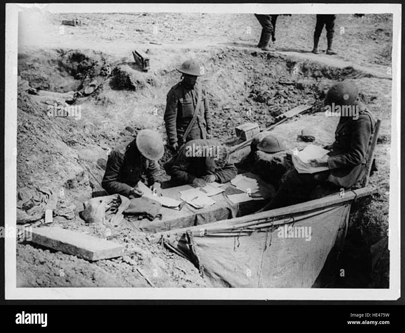A historic photograph of a trench orderly room, capturing a moment from ...