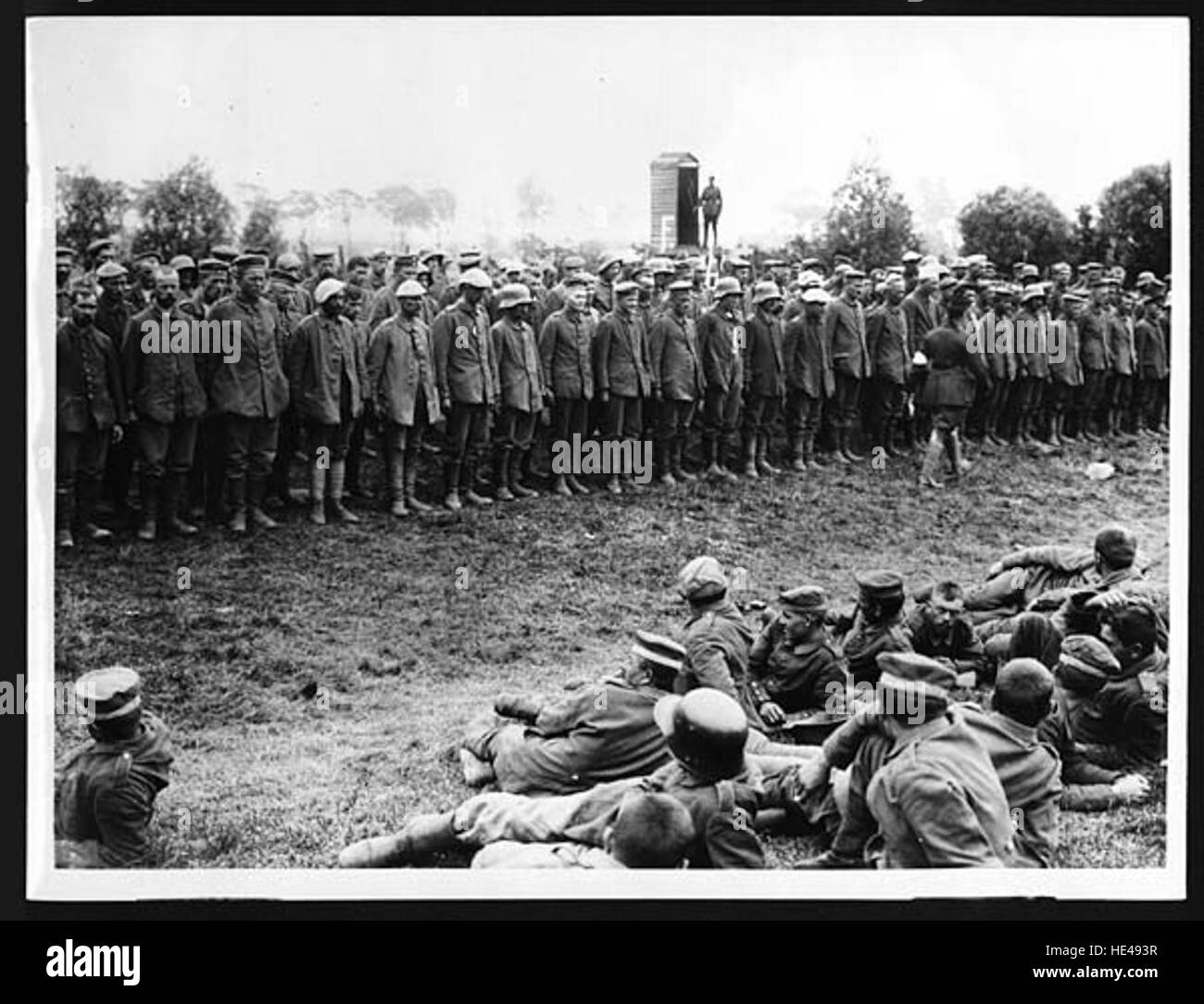 A photograph documenting German prisoners of war taken during World War II, lined up for examination. The image captures a pivotal moment in the conflict, showing the scale and severity of wartime captivity. Stock Photo