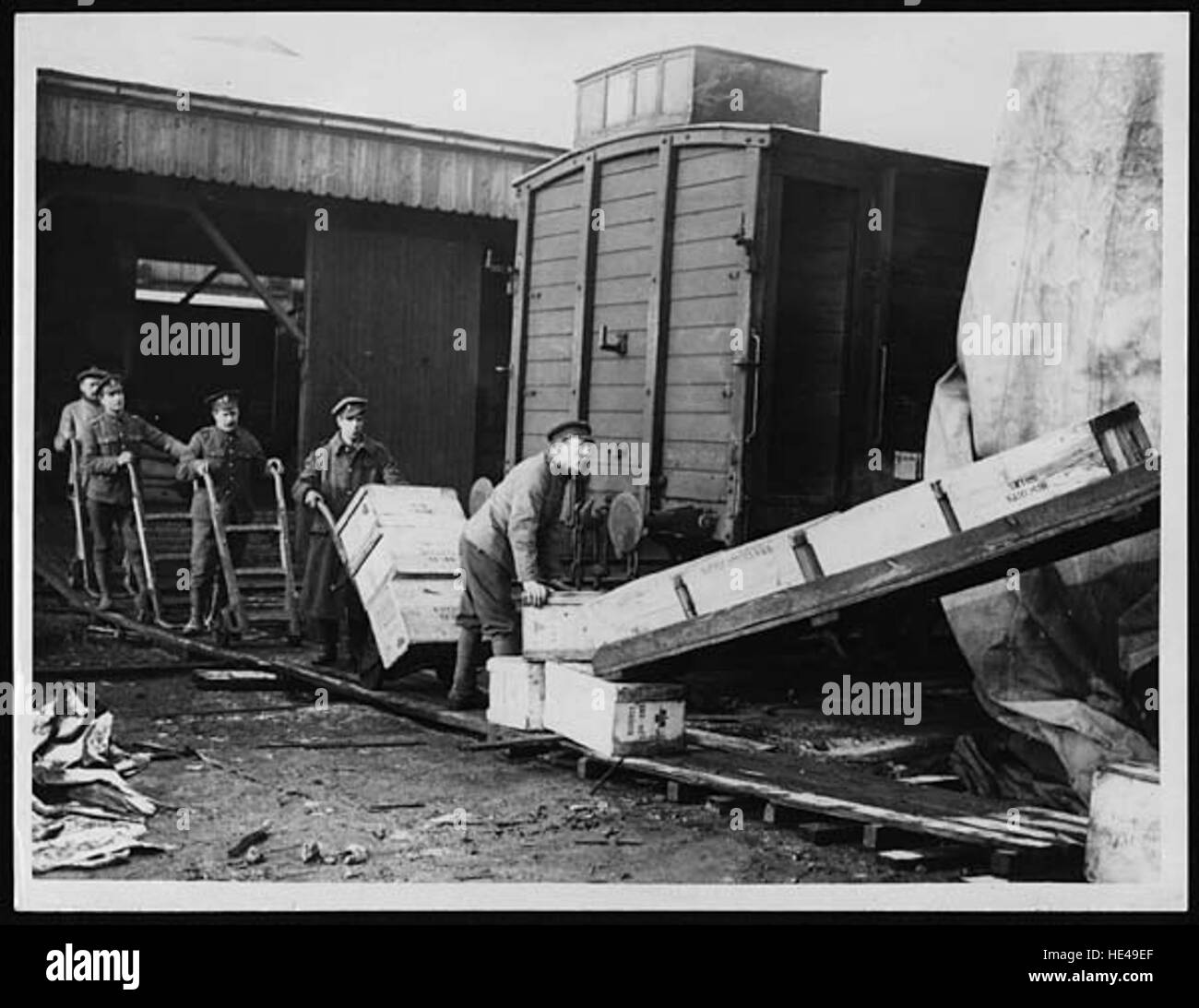 This historical image captures the unloading process from a ship to the slipway, showcasing an older maritime method of transferring goods. The image reflects past practices of transporting cargo and passengers during a bygone era, offering insight into historical maritime operations. Stock Photo