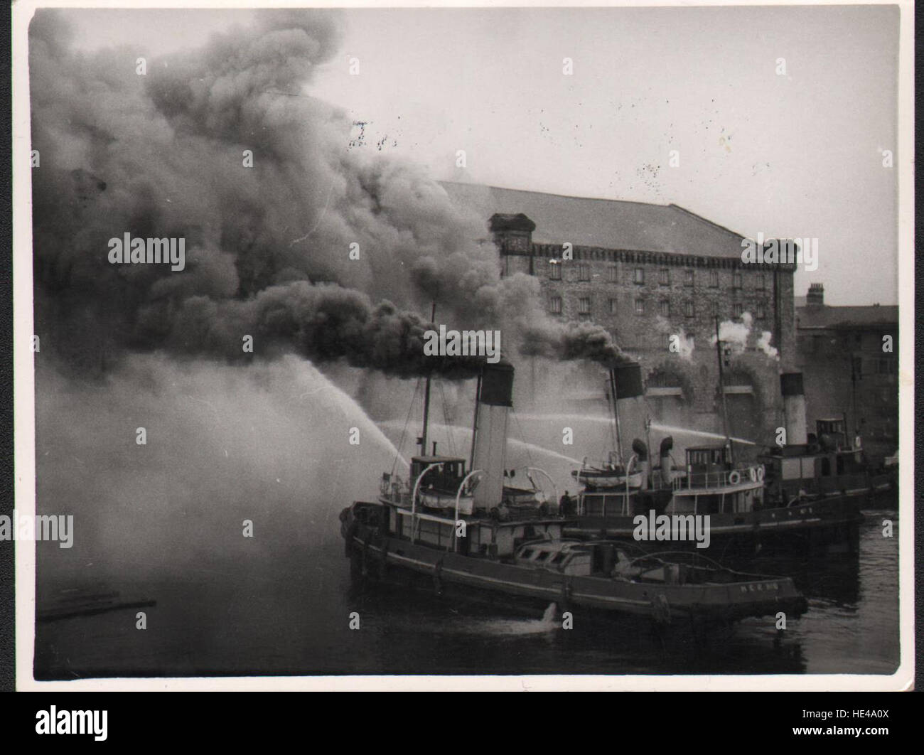 Tugs fighting the fire Match Factory fire 1954 Stock Photo Alamy