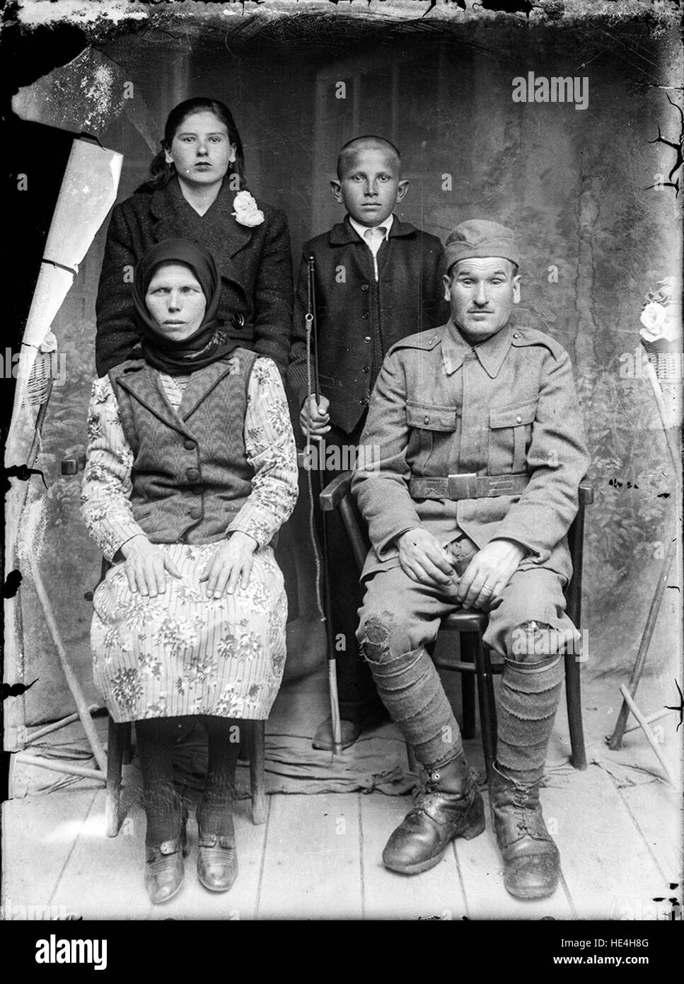 Family portrait, the man in the right is wearing an army uniform (soldier ro.wikipedia.org/wiki/Grad militar ( http://ro.wikipedia.org/wiki/Grad militar ) ), the boy in the middle is proudly holding a new whip - probably arrived at the photo studio by a horse wagon. Stock Photo