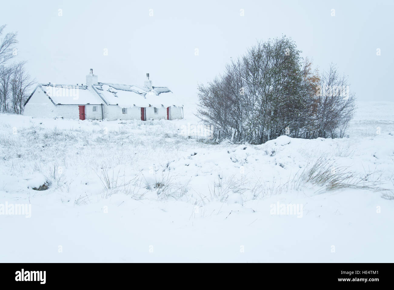 Traditional Scottish house by the west highland way footpath on Rannoch Moor, Glencoe in early winter snow. Scotland, UK Stock Photo