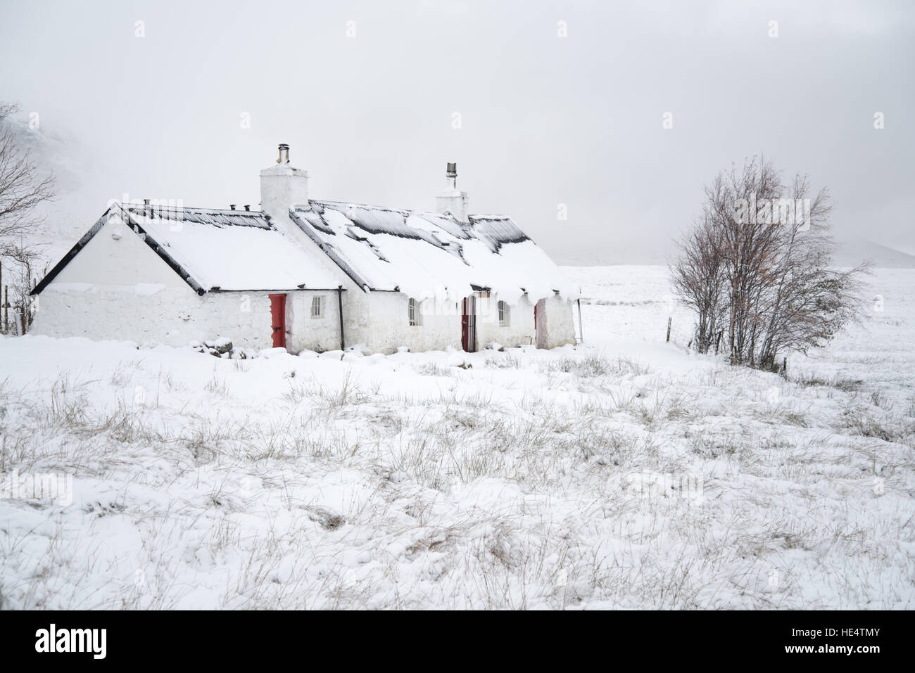 Traditional Scottish house by the west highland way footpath on Rannoch Moor, Glencoe in early winter snow. Scotland, UK Stock Photo