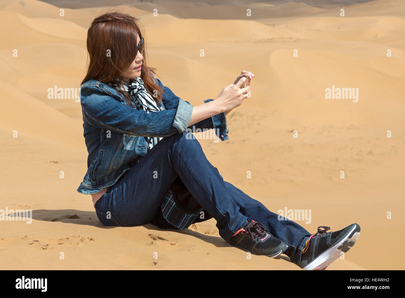 Chinese tourist taking selfie at Shapotou Scenic Area, Zhongwei, Ningxia, China Stock Photo