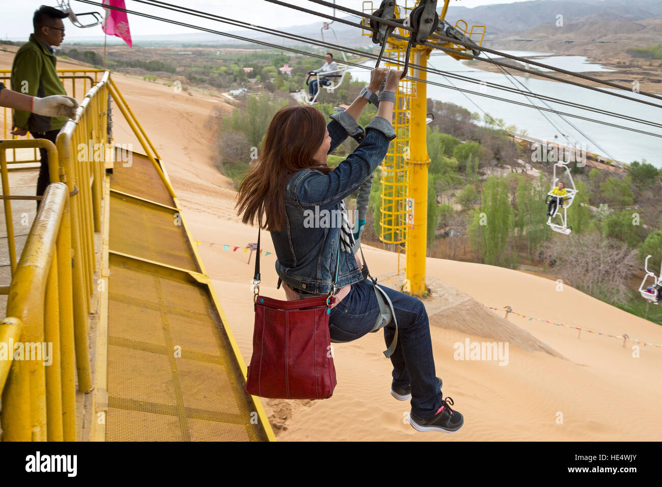 Chinese girl on zip glide, Shapotou Scenic Area, Zhongwei, Ningxia, China Stock Photo