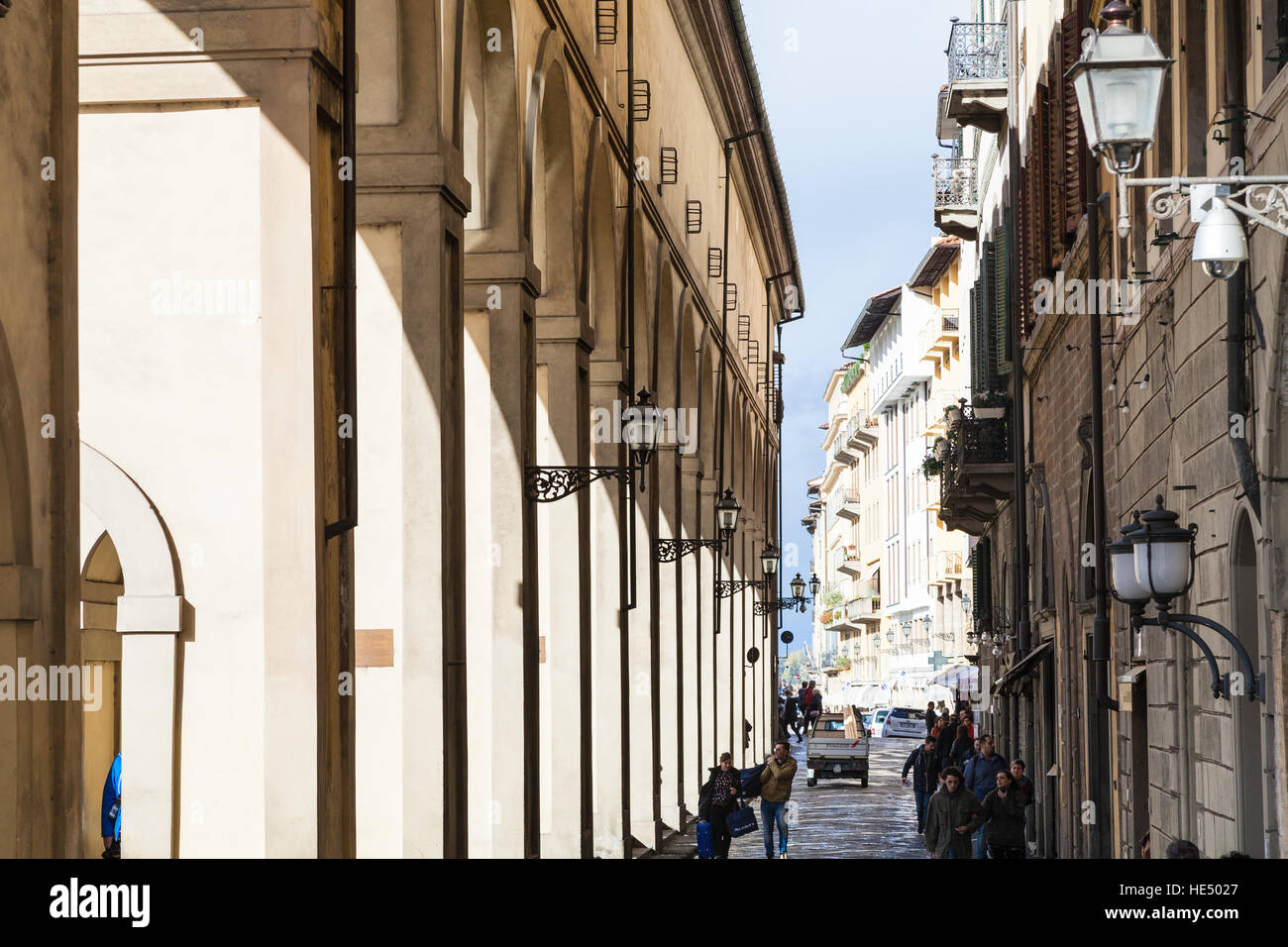 FLORENCE, ITALY - NOVEMBER 6, 2016: people walk near Vasari Corridor in autumn. The Vasari Corridor connects Palazzo Vecchio with Palazzo Pitti, it wa Stock Photo