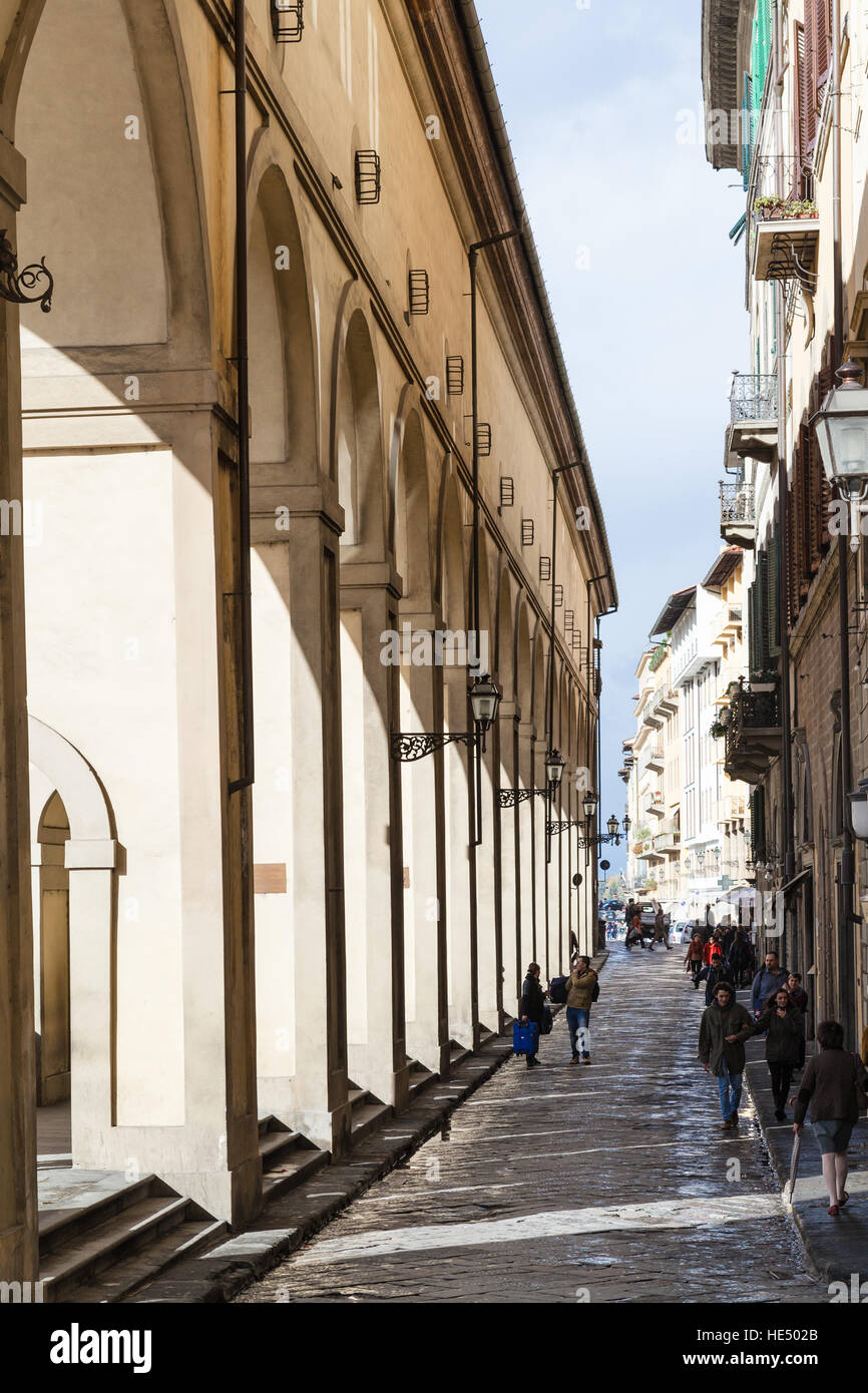 FLORENCE, ITALY - NOVEMBER 6, 2016: tourists walk near Vasari Corridor in autumn. The Vasari Corridor connects Palazzo Vecchio with Palazzo Pitti, it Stock Photo