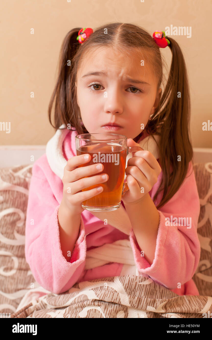 Sick girl has drink hot tea Stock Photo Alamy