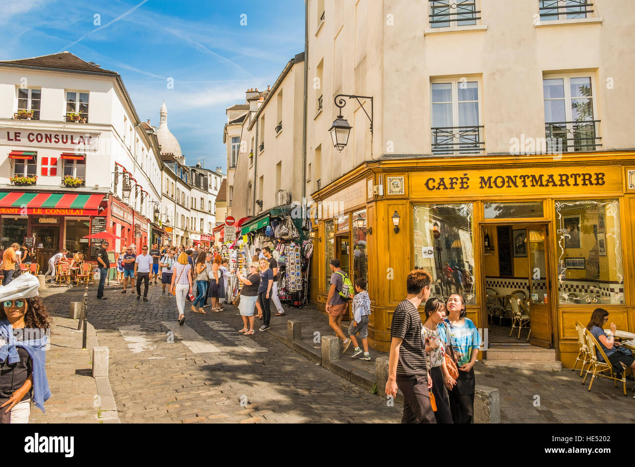 street scene montmartre district, tourists walking down cobblestone street Stock Photo